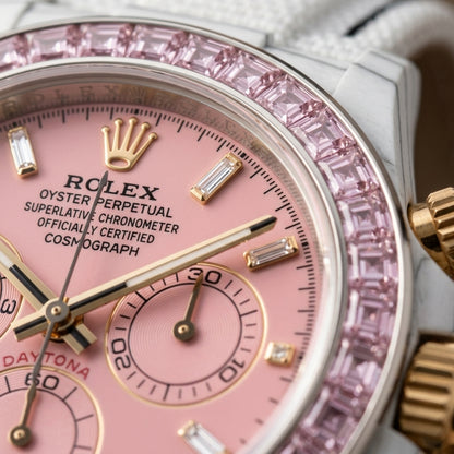 Macro of the pink dial with clear baguette markers and pink counters inside the pale pink stone bezel
