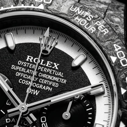 Macro of the black dial, the white chapter ring and the three black counters