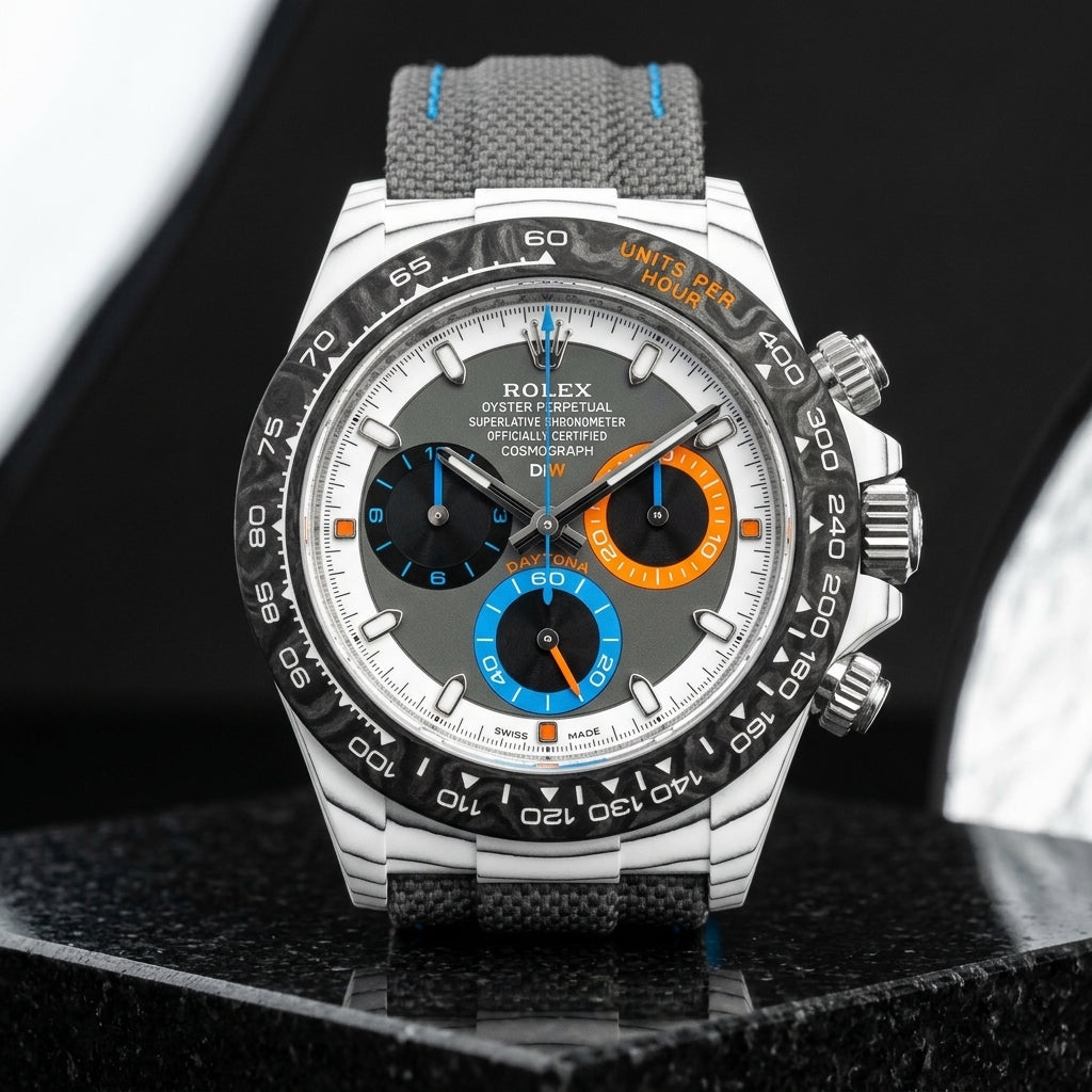 White CarboQuartz chronograph with a grey dial and orange and blue counters on dark stone