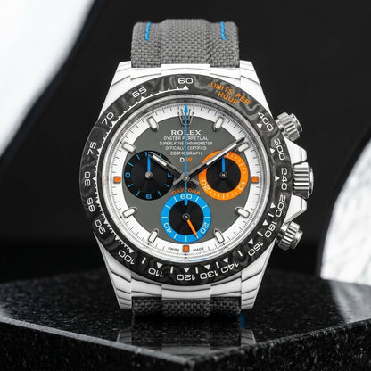 White CarboQuartz chronograph with a grey dial and orange and blue counters on dark stone