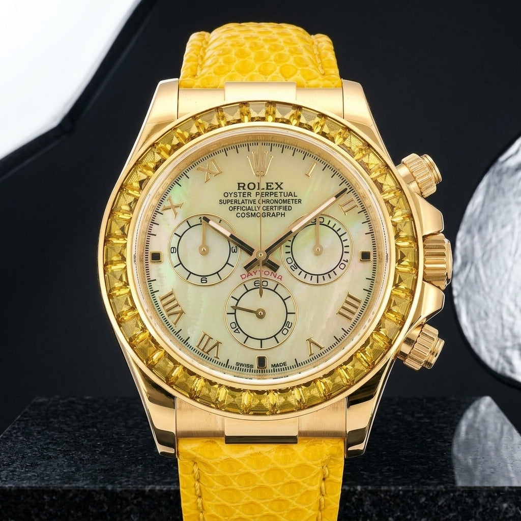 Gold-tone chronograph with a yellow mother-of-pearl dial and a golden-yellow stone bezel on a bright yellow lizard-grain strap, worn on the wrist below a navy suit cuff